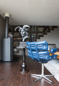 Bust on side table next to blue leather armchair in living room