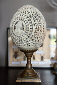 Engraved ostrich egg on metal stand