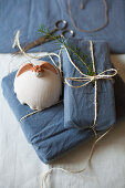 Pottery angel on gifts wrapped in blue fabric