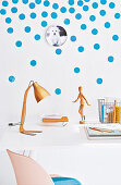 A white wall decoration with blue dots