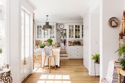 Bright open country-style kitchen with dining area and wooden floor