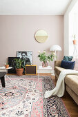Sofa, side table, standard lamp, mirror and rug in bright living room