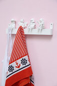 Coat pegs made from white-painted toys