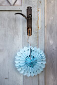 Handmade blue paper decoration hung from door