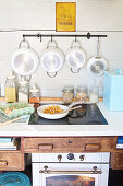 Rustic kitchen scene with pan of chanterelles, groceries and saucepans