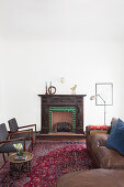 Vintage leather sofa, fireplace and chairs in lounge