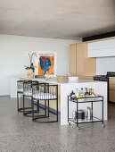 Semicircular chairs at kitchen island in modern architect-designed house