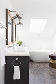 Double vanity and free-standing bathtub in the attic bathroom