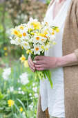 Woman holding bunch of narcissus