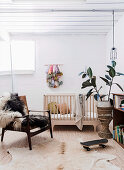 Armchair with fur, crib and houseplant in the baby room