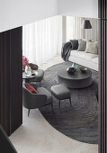 View of dark gray designer armchairs, coffee table and sofa in the living room