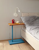 Blue, DIY side table with bamboo top and steel cable next to bed