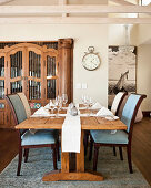 Set, rustic wooden table and upholstered chairs in dining area
