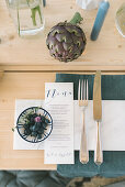 Cutlery and menu on set table