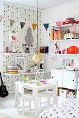Modular shelving in white child's bedroom with patterned wallpaper on accent wall