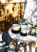 Cups and potted plants on wooden stools