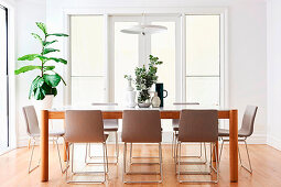 Dining table with designer chairs in a bright dining room