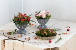 Three small flower arrangements in flan tin and metal bowls