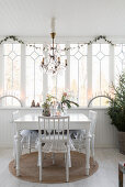 White table and chairs in festively decorated conservatory