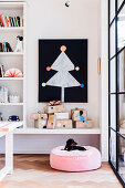 Stylized paper Christmas tree on black chalkboard, including gift on shelf and pillow with dog