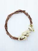 Wicker wreath decorated with spring flowers