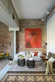Large red painting on brick wall in living room