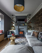Narrow, English-style living room in shades of grey