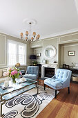 Light blue upholstered chairs in the living room with gray walls