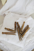 Vintage-style dolly pegs on stacked laundry
