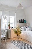 Teenager's bedroom with white wood cladding decorated for Christmas