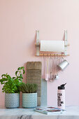A DIY shelf made of leather straps for kitchen utensils