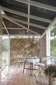 Vintage table set for afternoon coffee on veranda with screens