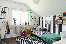 Wide stripes and graphic patterns in monochrome child's bedroom