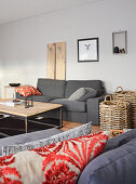 Grey couch, coffee table and baskets in living room