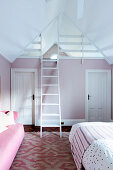 Girl's room in pink and white with ladder to the gallery under the roof