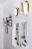 Fashion accessories and photo gallery on white wall