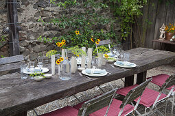 Flower arrangements on rustic set table on terrace
