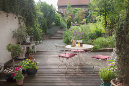 Vintage table, chairs and potted plants on terrace