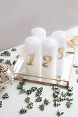 DIY Advent arrangement of candles and scattered decorations on mirrored tray
