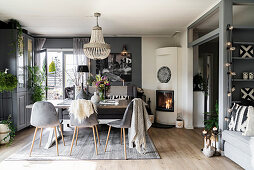 Fireplace in dining area of open-plan interior in shades of grey