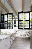 Wash basin in elegant bathroom with marble covering