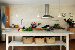 Long table with storage baskets as a kitchen island