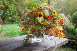 Autumn bouquet of hydrangeas, chrysanthemums, sunflowers and oak leaves