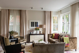 Furniture with velvet upholstery in earthy shades in large, luxurious living room