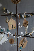 Christmas-tree decorations on stylised tree handmade from twigs
