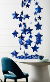 Blue DIY paper stars over dining table