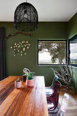 Dining room with green walls and corner windows