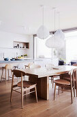 Designer chairs on the modern wooden table in the kitchen