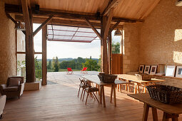 Barn converted into workshop studio with wooden deck and view of landscape