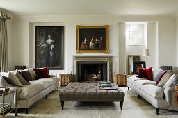 Drawing room with upholstered furniture, fireplace and paintings